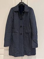 Front view of blue and white check reversible coat on hanger