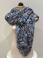 Scarf draped on mannequin showing pattern and fringe