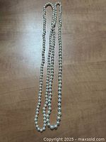 Entire length of pearl strand laid straight