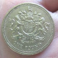 Reverse side showing crowned Royal Arms and ONE POUND legend