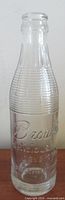 Full view of embossed Brown's soda bottle