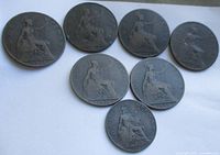 Obverse view of seven Queen Victoria coins showing seated Britannia dates
