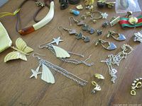 Overall view showing assorted earrings, pendants, brooches and chains