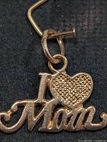 Front view of 10K gold I ♥ Mom pendant showing design and bail
