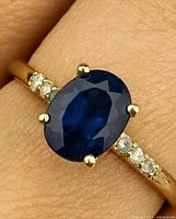 Close-up of sapphire and diamond ring on finger