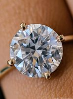 Close-up of diamond in four-prong setting on gold band