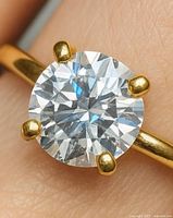 Close-up of round lab diamond in four-prong 10K gold setting