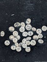 Close-up of loose round diamonds on black background