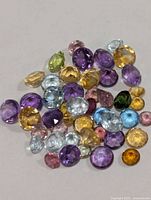Loose multicolour faceted gemstones spread out