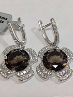 Front view of both earrings showing smokey quartz centres and pavé clear stones