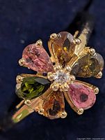 Top view of ring showing six tourmaline stones and centre clear stone