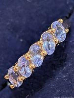 Top view showing five oval tanzanite stones and prong settings