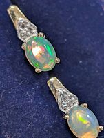 Front view of both earrings showing opals and accent stones