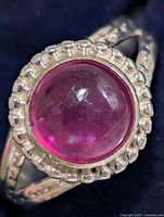 Front view showing ruby cabochon and decorative bezel