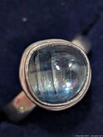 Front view showing cabochon blue stone and bezel setting
