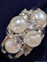 Top view showing cluster of pearls and accent stones on silver band