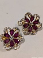 Front view showing ruby petals and CZ borders