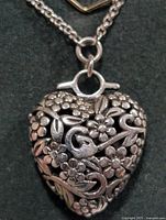 Close view of floral heart pendant on chain