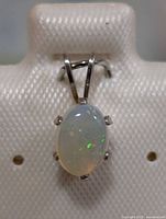 Front view of sterling silver pendant showing opal and setting