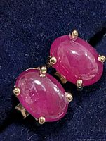 close-up of both ruby studs in setting