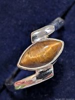 Front view of silver ring with marquise tiger eye stone