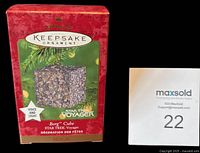 Front of red Hallmark Keepsake box showing product name and image