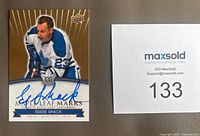 Front of Eddie Shack autographed trading card and lot number card