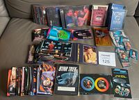 Overview of stacks of Star Trek cards, Stardiscs, bookplates and boxed items