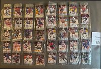 Binder page showing multiple sealed NHL stickers in pockets
