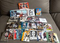 Wide view of entire lot spread on sofa showing bulk cards and inserts
