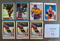 Front view of six rookie hockey cards in holders