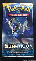 Front of sealed Sun & Moon booster pack with Lunala artwork