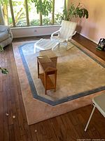Full view of area rug in room showing color pattern and size
