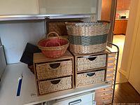 Overall lot showing two drawer organizers stacked, baskets on top and alongside