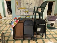 Overall lot showing catering table, folding chairs, patio chair, step stool and mat