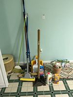 Overall lot with long-handled tools, bucket and cleaners