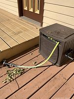 Hose reel box with hose attached on deck