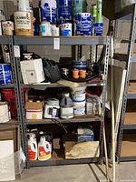 Full view of metal shelving unit with contents shown for scale