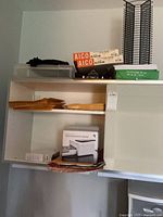 Shelf with CD holder tower, optical media accessories and various boxes