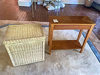 wood side table next to wicker trunk
