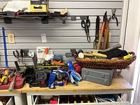 Workbench with drill, socket set, hand tools, hardware