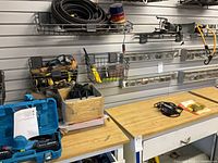 Workbench view with chainsaw case, glove box, hose, strobe light, hardware organizers