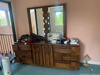 full view of dresser with attached mirror and visible surface wear