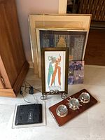 Group view of framed art, weather station and digital frame