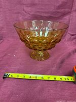 Bowl on pedestal with tape measure showing diameter