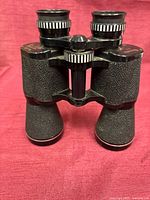 Front view showing full binocular body and textured barrels