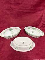Two lidded casserole dishes and one base displayed, showing overall design and quantity