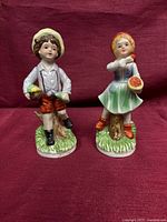 Full view of both porcelain figurines