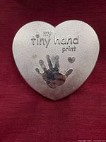 Front view of heart-shaped keepsake box showing embossed text and design