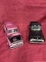 Front angled view of both trucks showing colors, grille details